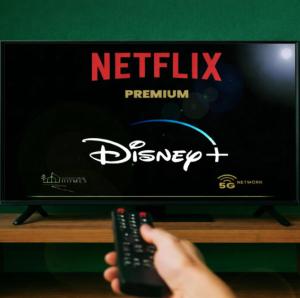 a person holding a remote control in front of a television at 4SEASONS -- Emerald Summer Lounge in Aalborg