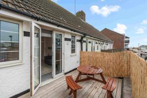 a wooden deck with a table and two chairs at Ferry Fab Pad By My Getaways in Brighton & Hove