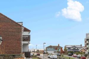 a brick building on a city street with cars parked at Ferry Fab Pad By My Getaways in Brighton & Hove