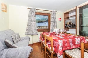 a living room with a table and a couch and a chair at Casa di Maen in Valtournenche +14 photos