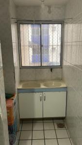 a bathroom with a sink and a window at Solares Residence in Teresina +4 photos