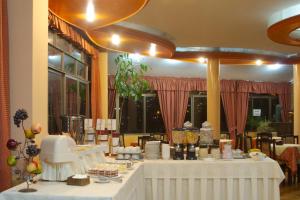a dining room with white tables with food on them at Hotel Condeza in La Paz +19 photos