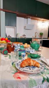 a kitchen counter with a table with a plate of bread at Il Sonetto Boutique Apartment - private garage in Mantova +44 photos