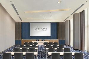 a conference room with a projector screen and chairs at Four Points by Sheraton Nha Trang in Nha Trang +37 photos