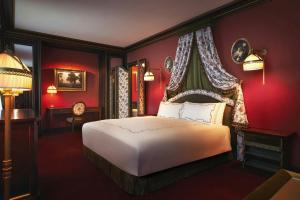 a bedroom with a bed with red walls at L'Escape, a Luxury Collection Hotel, Seoul Myeongdong in Seoul +82 photos