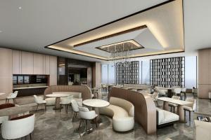 a restaurant with tables and chairs in a lobby at AC Hotel by Marriott Manila in Manila