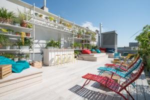 
a patio area with chairs, tables, and benches at Ruby Marie Hotel Vienna in Vienna
