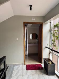 a hallway with a door and a potted plant at Comfy cozy in Kira +3 photos