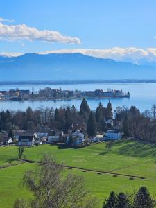 a view of a lake with mountains in the background at Gästehaus Cavallo in Achberg