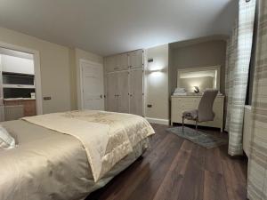 a bedroom with a bed and a desk and a chair at Time Out Accommodation in Cahersiveen