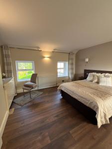 a bedroom with a bed and a chair in it at Time Out Accommodation in Cahersiveen