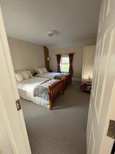 a bedroom with two beds and a window at Time Out Accommodation in Cahersiveen