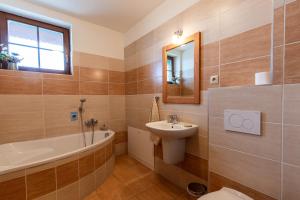 a bathroom with a sink and a tub and a toilet at Vila Araya Mlynica in Mlynica +110 photos