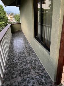 a walkway next to a building with a window at Hotel Diana cazadora in Zihuatanejo +12 photos