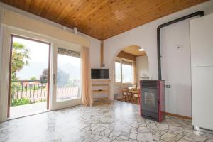 a living room with a kitchen and a large window at Villa Laura in Germignaga
