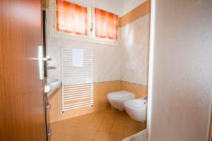 a small bathroom with a toilet and a sink at Villa Laura in Germignaga +18 photos