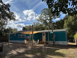 a green and white trailer with a house at Prime Crystal River location! in Crystal River