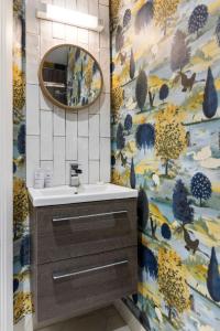 a bathroom with a sink and a mirror at Hestia House in Derry Londonderry +55 photos