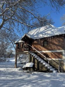 a log cabin with snow on the roof at Cross Over Zemun in Belgrade
