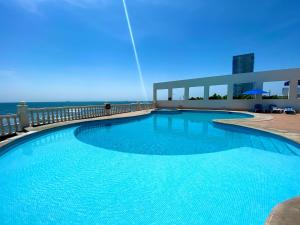 a large swimming pool on the side of a building at Astur Hotel & Residence in Veracruz +34 photos