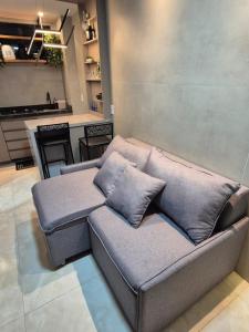 a couch with pillows sitting in a living room at Apt 18 - VR Village in São Luís