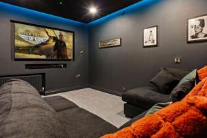 a living room with a couch and a big screen tv at Hestia House in Derry Londonderry