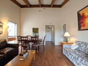 a living room with a couch and a table at Spacious 2 bd 2 bth Condo at Cedar Lodge Laconia in Laconia