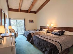 a bedroom with two beds and a window at Spacious 2 bd 2 bth Condo at Cedar Lodge Laconia in Laconia