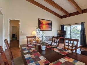 a living room with a table and a dining room at Spacious 2 bd 2 bth Condo at Cedar Lodge Laconia in Laconia