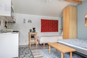 a small room with two beds and a kitchen at Cosy stay in southern Malmo in Malmö