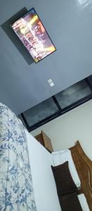 a tv on the ceiling of a bedroom at Residence Maachaalah in Saint-Louis