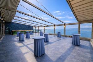 a row of stools in a building with a view of the water at TRYP by Wyndham Izmit in Kocaeli +47 photos