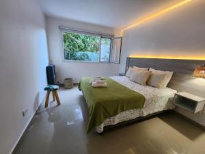 a bedroom with a large bed and a window at Luz de Sol in Plottier