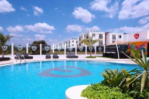 a large blue swimming pool with buildings in the background at Moonlight mirage in Nairobi