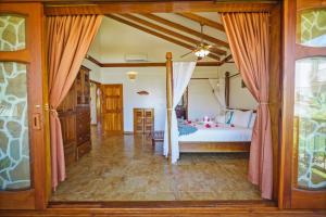 a bedroom with a bed in a room at Hopkins Bay Belize a Muy'Ono Resort in Hopkins