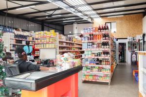 a man sitting at a counter in a store at Moonlight mirage in Nairobi +2 photos