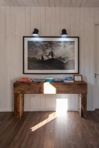 a table in a room with a picture on the wall at Hosteria El Puma in El Chalten