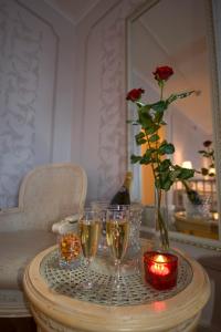 a table with glasses of champagne and a vase with a rose at Quality Hotel Bodensia in Boden
