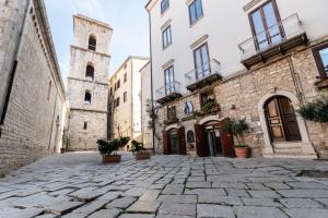 a cobblestone street in an old town with a church at B&B Al Convento in Potenza