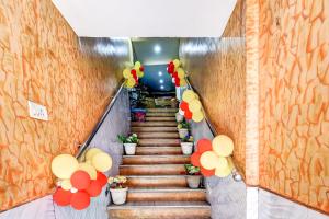 a staircase in a building with red and yellow balloons at Hotel O Lord Shiva in Bankipur
