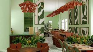 a dining room with tables and chairs and plants at Hilton Miami Beach in Miami Beach