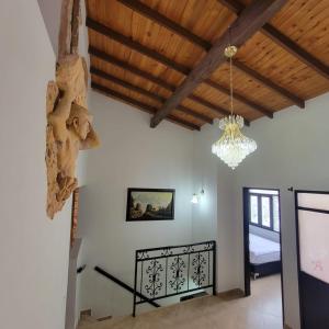 a living room with a chandelier and a staircase at Viviendas Turísticas in Jericó