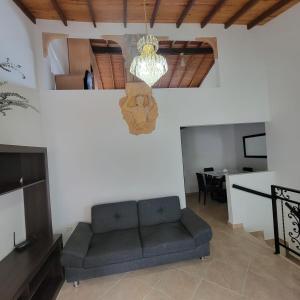 a living room with a couch and a chandelier at Viviendas Turísticas in Jericó