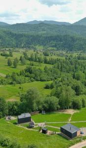an overhead view of a green field with buildings and trees at Feeling Freedom in Tukhlya