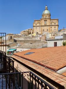 a building with a clock tower on top of a roof at Principe Giardinelli in Piazza Armerina