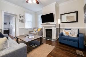 a living room with a couch and a fireplace at Charming Historic Condo with Pool in Savannah
