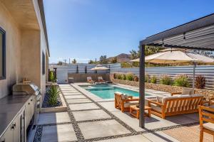 a backyard with a swimming pool and a house at Luxury Desert Villa with Pool and Spa in Yucca Valley