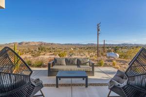 a living room with a couch and two chairs at Luxury Desert Villa with Pool and Spa in Yucca Valley