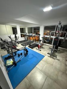 a gym with several treadmills and machines in a room at Edificio lillion 2 in Mar del Plata