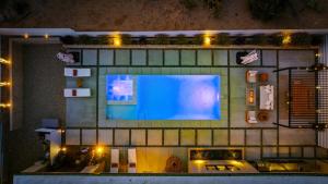 a large screen tv on a brick wall with lights at Luxury Desert Villa with Pool and Spa in Yucca Valley